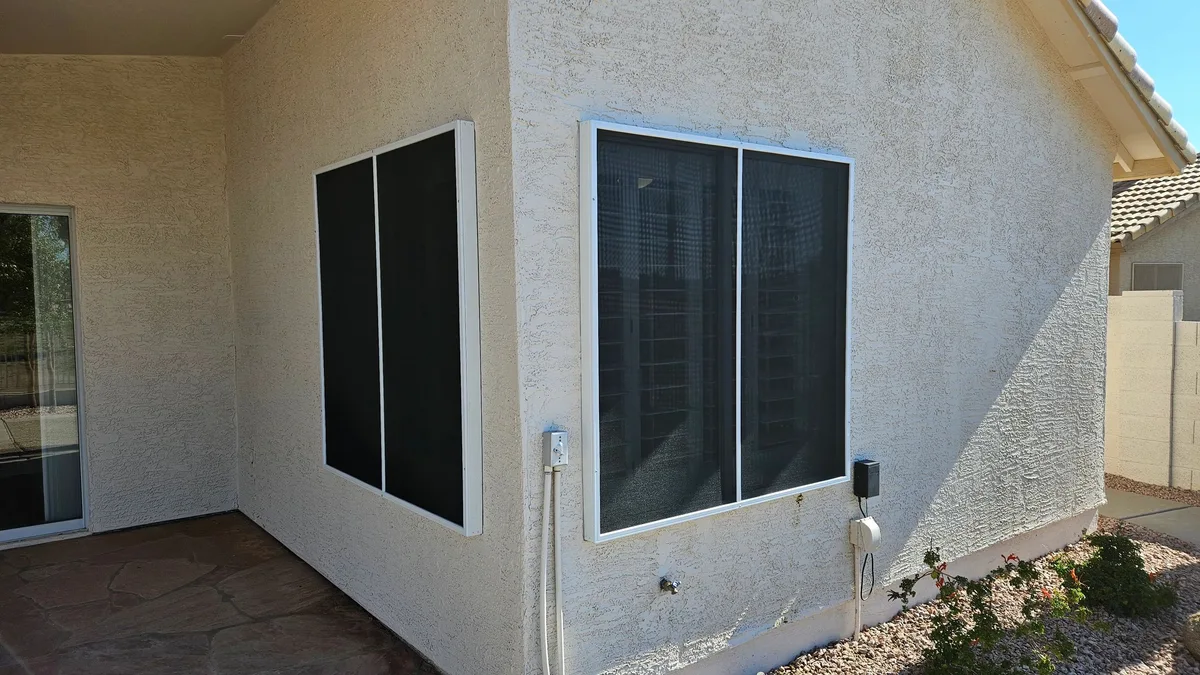 Screen assembly with stand-off frames at corner windows