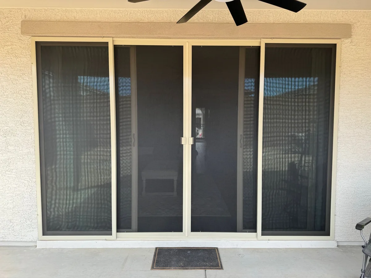 Sliding patio doors beneath a covered outdoor area