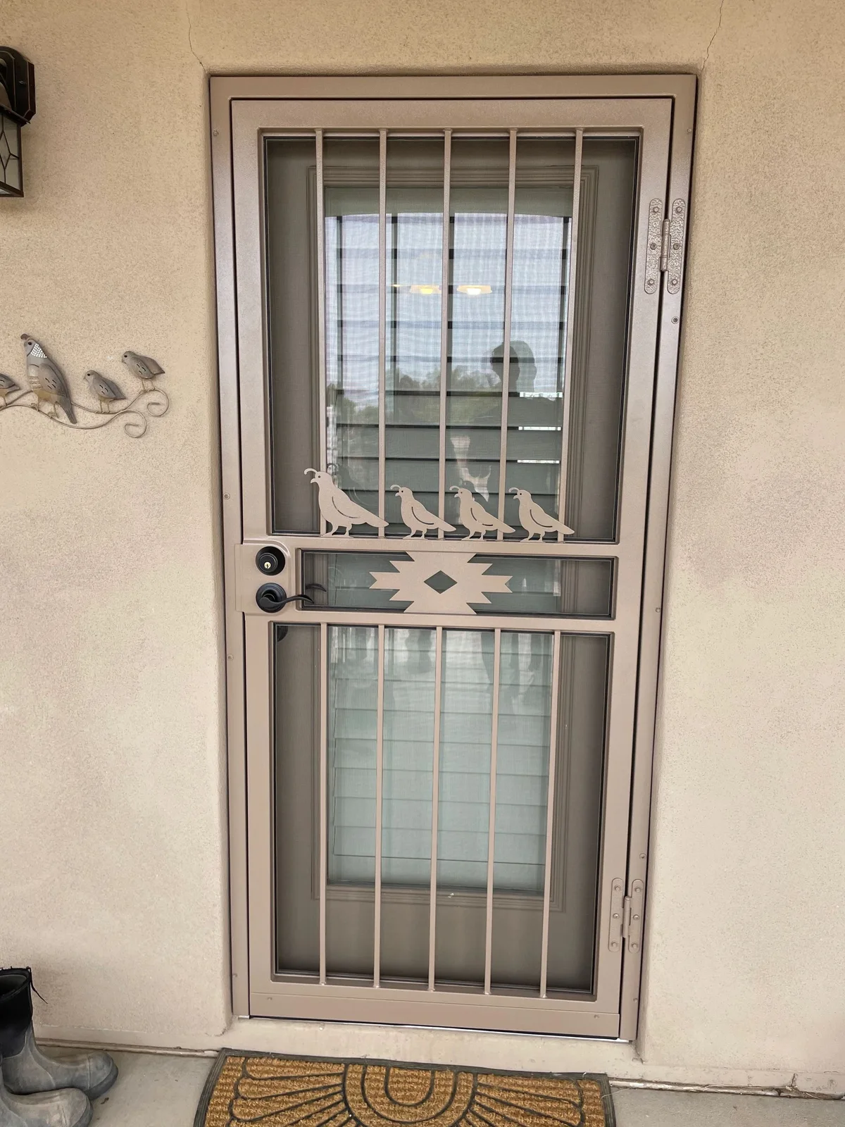 Decorative metal screen door with patterned panels
